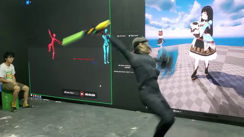 Motion capture performer driving a VTuber character on an LED screen