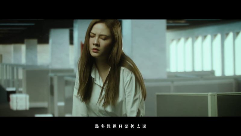Still from Angela Pang music video with a performer in a quiet indoor scene