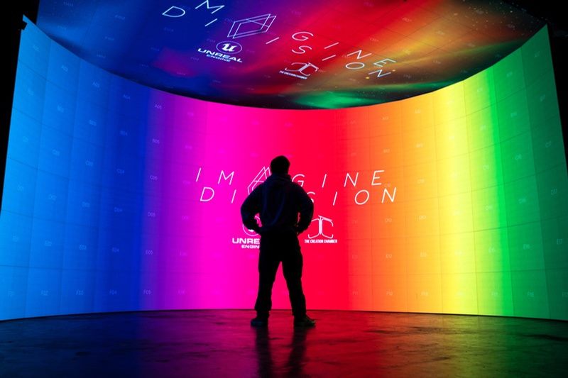 Person standing inside a curved LED virtual production volume
